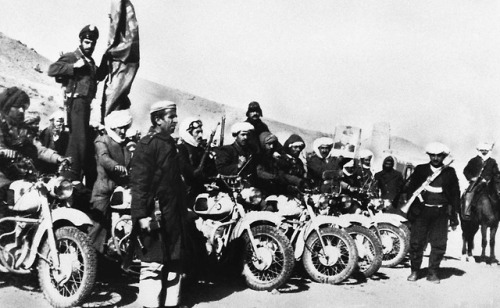 Afghan guerrillas, armed and equipped with motorcycles, prepare foraction with Soviet and government
