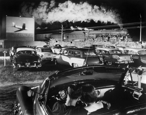 Couple at drive-in, while steam locomotive passes / photo by O. Winston Link, Iaeger, West Virginia,