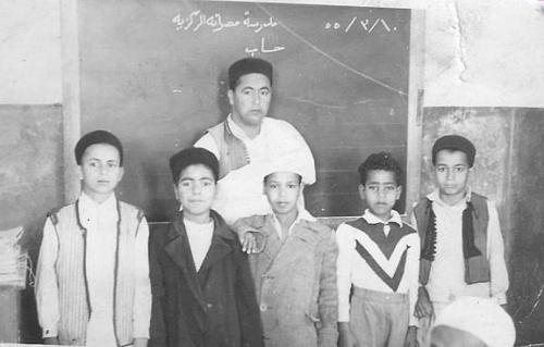 libyazamaan: A teacher and his students. According to the text on the chalkboard, they were apparent