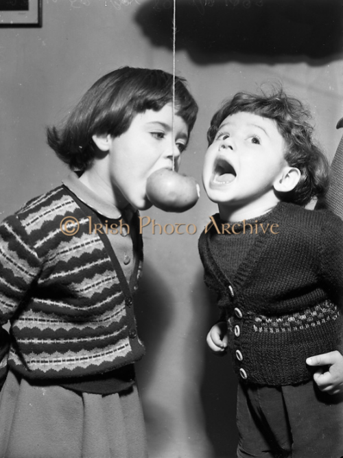 saoirse-eireann: Children playing snap apple on Halloween at Botanic Road, Glasnevin, 28th October 1