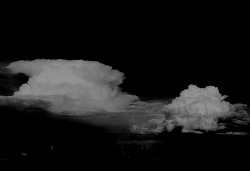 coloursarefine:  two clouds. - in front of black space. 