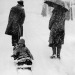 undr:Unknown Photographer. Parents bringing their child on a sledge to the school.