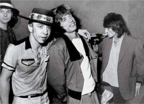 groovyscooter:  Stevie Ray Vaughan and Mick Jagger (Ronnie Wood quaffing a beer)