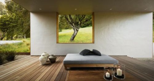 #BagoesTeakFurniture This home has a covered outdoor living room with a day bed and fireplace. A cut