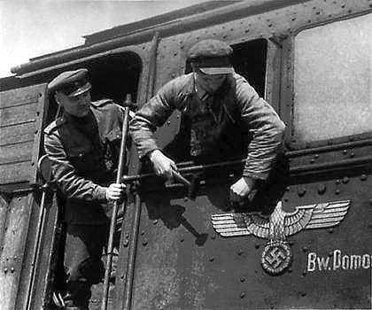 sovietpartisans:  Removing the swastika from a German train, ca. 1945