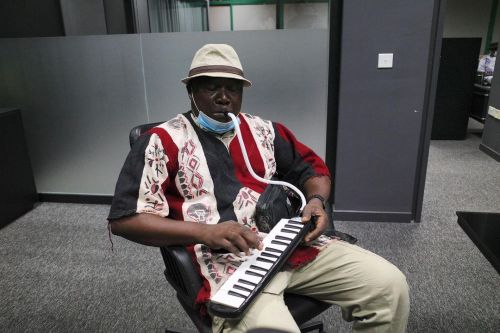 Member of the Ebo Taylor and the Saltpond City Band, Long John, plays a melodica before a live perfo