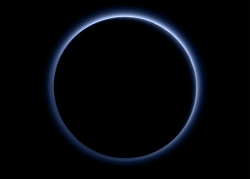 npr:  Color images of Pluto released by NASA this year show the dwarf planet has a reddish brown surface. But an even newer photo shows that despite those colors, Pluto’s atmosphere has a blue haze. The discovery results from the New Horizons probe’s