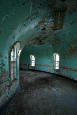 ianference:  This curved connector hallway joined the two sandstone wards at the H. H. Richardson-designed Buffalo State Hospital, probably the most architecturally rich asylum in America.  The curvature was a brilliant forethought - decades after the