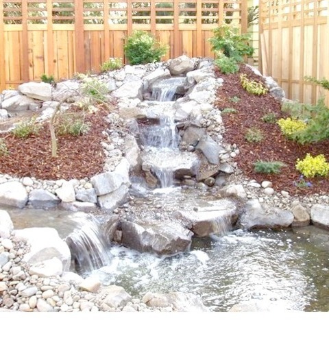 Pond Landscape DenverPhoto Of A Sizable, Rustic Backyard With Stone Landscaping Taken In The Summer.