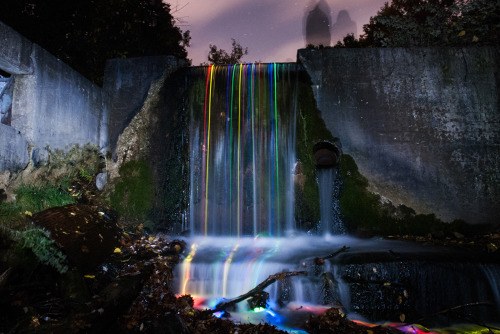 fromthelenzmedia:Neon Falls.Light trails of glowsticks shown through the movement of the water.