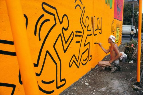 twixnmix: Keith Haring painting a mural on Houston Street and Bowery in New York City, 1982.   (Phot