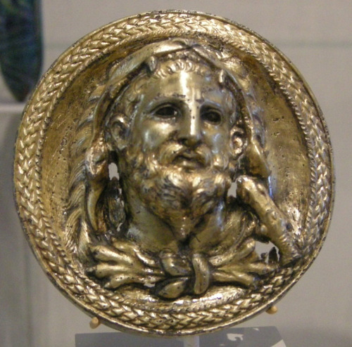 lionofchaeronea: Silver-gilt roundel bearing a bust of Heracles.  Artist unknown; Hellenistic p