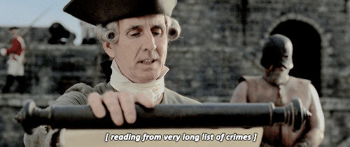 A town crier reads from a long list of crimes.