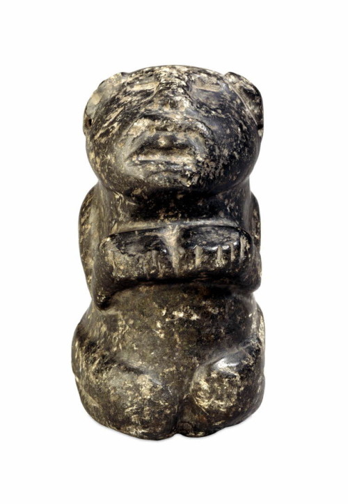 Kneeling human figurine, made of a jade-like stone (Olmec or Aztec,Mexico).  Both earlobes are 