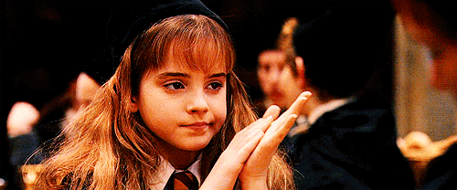 Hermione clapping half-heartedly