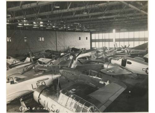  P-51s and utility aircraft weather a hurricane stuffed into a hangar at Bartow Army Airfield, Flori