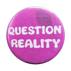 a purple pin with white text reading 'QUESTION REALITY'