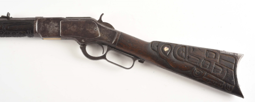 Winchester Model 1873 lever action rifle with stock carved by Native Americans of the Pacific Northw