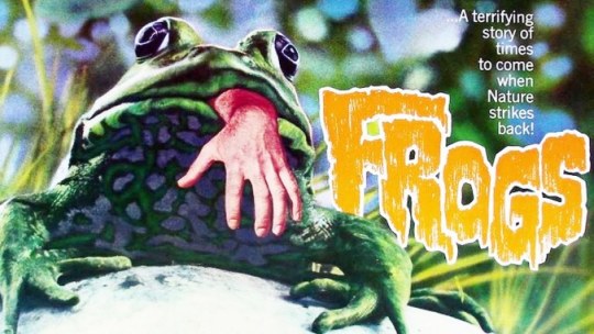 Poster for Frogs (1972). Shows a frog with a human hand in its mouth. Text: A terrifying story of times to come when Nature strikes back!