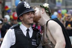 maleinstructor:    A Metropolitan Police officer receives a kiss on the cheek from a participant in the Pride in London Parade. 06/27/2015