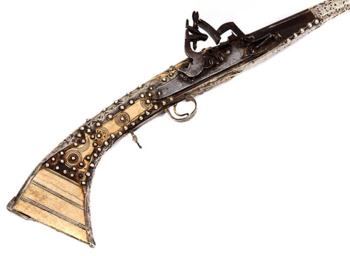 Ornate Moroccan snaphaunce, musket with silver and bone mounts, 19th century.from Helios Auctions
