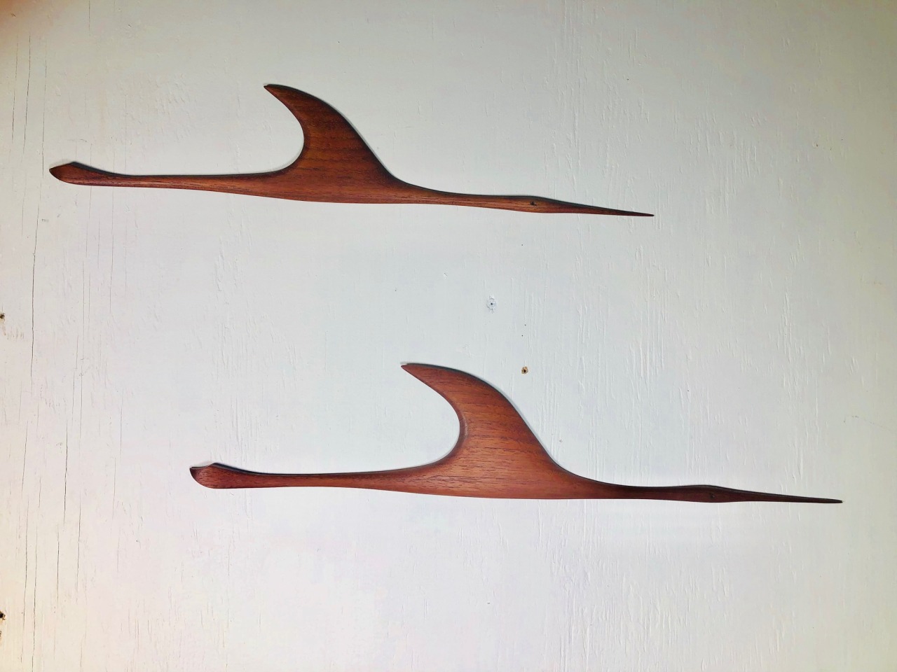 <p>Gorgeous pair of German teak cranes from the 1960s.<br/>Larger crane is 21" long and 4" wide at the widest point.<br/>Smaller crane is 18.5" long and 3.5" wide.</p>