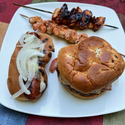 Memorial Day carnivore’s harvest feast. Burger, Hotdog, grilled shrimp and barbecue chicken all cook