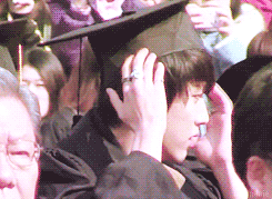 soegogi:   Lee Sungyeol student having trouble with his too-small-for-his-head graduation cap and asking Kim Sunggyu student on his right and Kim Myungsoo student on his left if he looks pretty.  