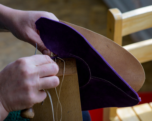 Hand stitching viola uppers in the workshop.