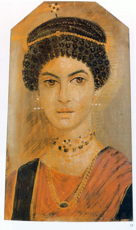 Mummy portrait of a woman with a ringlet hairstyle, an orange chiton with black bands and rod-shaped