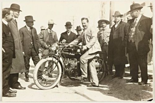 Pancho Villa posing with an Indian motorcycle, 1914.