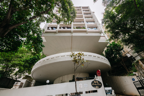 Standing on a round, typically brutalist car ramp, which accesses and structurally supports the buil