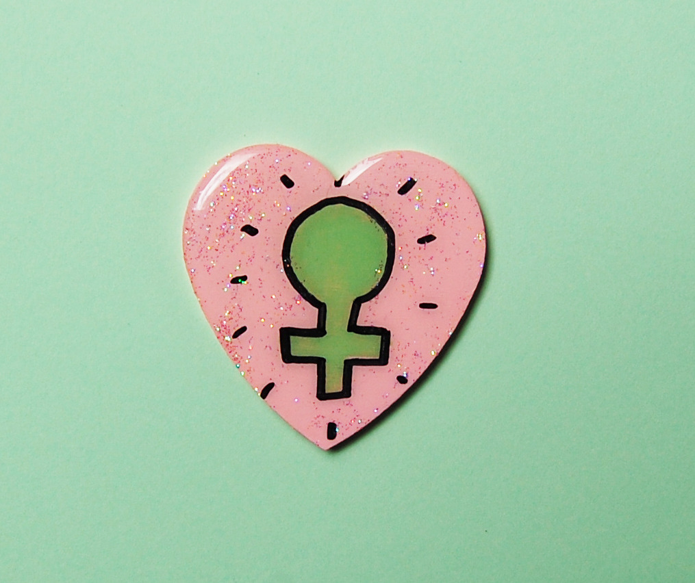 cryybabies:  pink FEMINIST venus symbol glitter heart brooch xo  Girl power! xo 