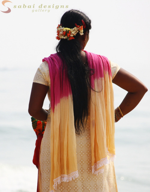 Local womem in traditional dress by the beach in Mahabalipuram, India