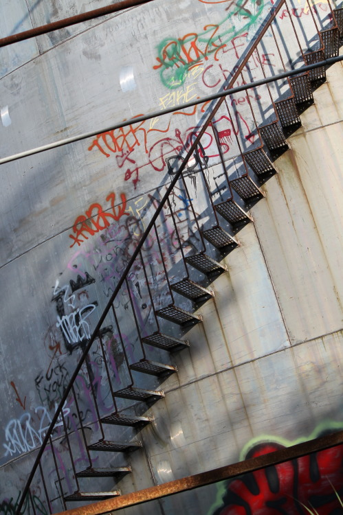 Local graffiti on the outside of an abandoned industrial silo.