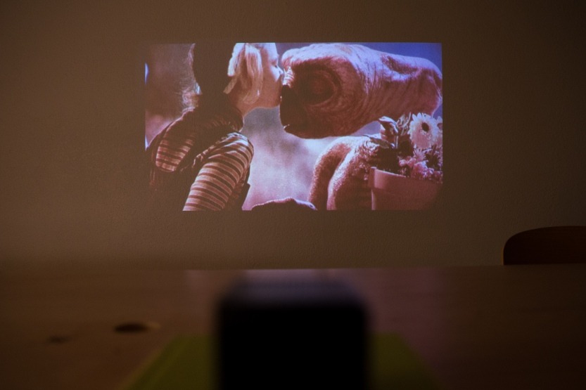 photojojo:  You can find TONS of portable projectors online, but most have lackluster