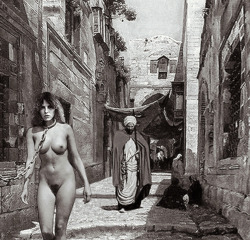 hornysylviagroess:  What is this? (found at imagefab) Could be a filmset. A slave? Pulled trough the streets of an ancient Arabian town. Naked! When? Looks like 100 years ago! A sex-slave? And who is pulling the heavy chain? And who is the man following