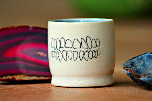 xcatalicious:  This one’s for my tea drinking homies! Wheel thrown porcelain tea cup with human teeth and dog jaw bone hand painted on opposite sides covered in a cracking clear glaze. You can buy it right hurrrr if you want…not trying to force anything,