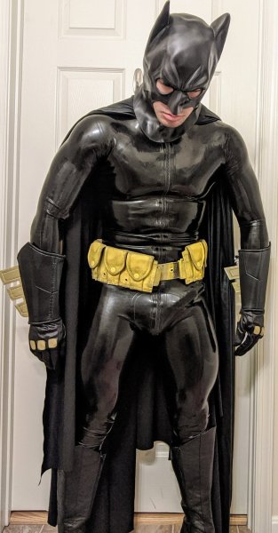 leatherglove-wong:Rubber Batman My Rubber Batman-Bot ran out of power just before we went to a cosplay party. I guess we’re going to have stay home for the night. Am I sad? Not at all! Look at his member right there. He was excited just to go to the