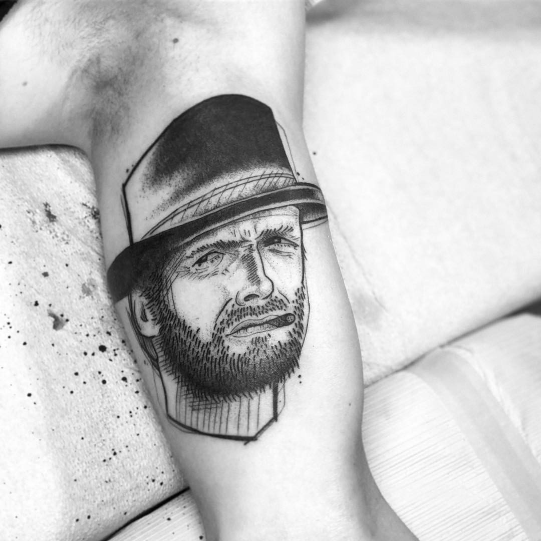Black and grey Clint Eastwood tattoo on the inner