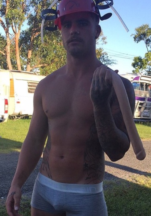 cutcockconn:  circumcisedperfection:  Got to love cut Aussies   This Aussie’s obvious circumcised cock is superbly on display in his tight grey undies. And he’s holding a massive dildo??