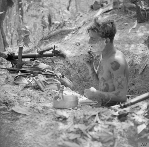 bastardkeaton: Commonwealth soldier shaving in a foxhole, WWII