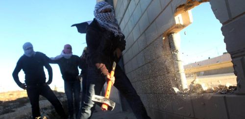 micdotcom:  Palestinian youth break through separation wall to remind the world of their own “Berlin