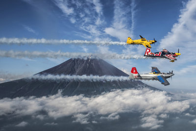 Martin Sonka of the Czech Republic (dark blue plane) leads Nigel Lamb of Great Britain (yellow) and Yoshihide Muroya of Japan (silver) past Mount Fuji prior to the third stage of the Red Bull Air Race World Championship in Chiba, June 1st 2016....