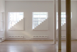 Installation for three windows, 2013. 243 hand-sanded Styrofoam bricks. Dimensions variable. Installation view