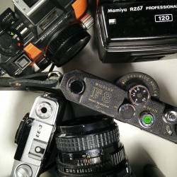 smellslikechemistry:  My desk all day everyday. Too many cameras to even fit in backpacks. #nicosphotographyshow #nikonosv #mamiyarz67 #olympuspen #wideluxf8 #pentax67