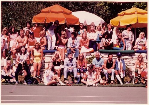 Captured roller skating and talking to friends, Hugh Hefner enjoys his 1979 Playboy Mansion Rollerpa