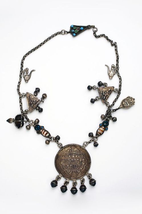 Jewish amulet necklace with khamsa, shells, acorns, bells and pendant inscribed with names of God. I