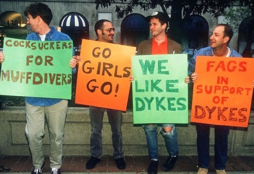 lesbianherstorian:  chris (last name unknown), david b. feinberg, john weir, and wayne kawadler held signs of solidarity, hyped up the crowd, and gave hugs at the first D.C. dyke march. footage from dyke tv, photograph by porter gifford, april 1993