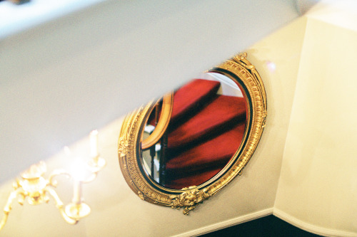Gold mirror and red stairs, The Gore Hotel, London. 